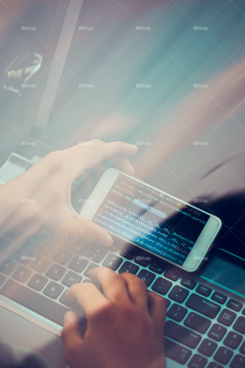 Hacker using computer, smartphone and coding to steal password and private data. Screen displaying program code, website development, application building, password and private data