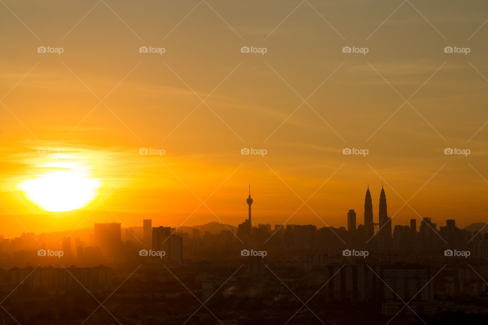Kuala Lumpur skyline sunset. Kuala Lumpur skyline, city scape during Orange sunset. Petronas tower and TV tower clearly visible