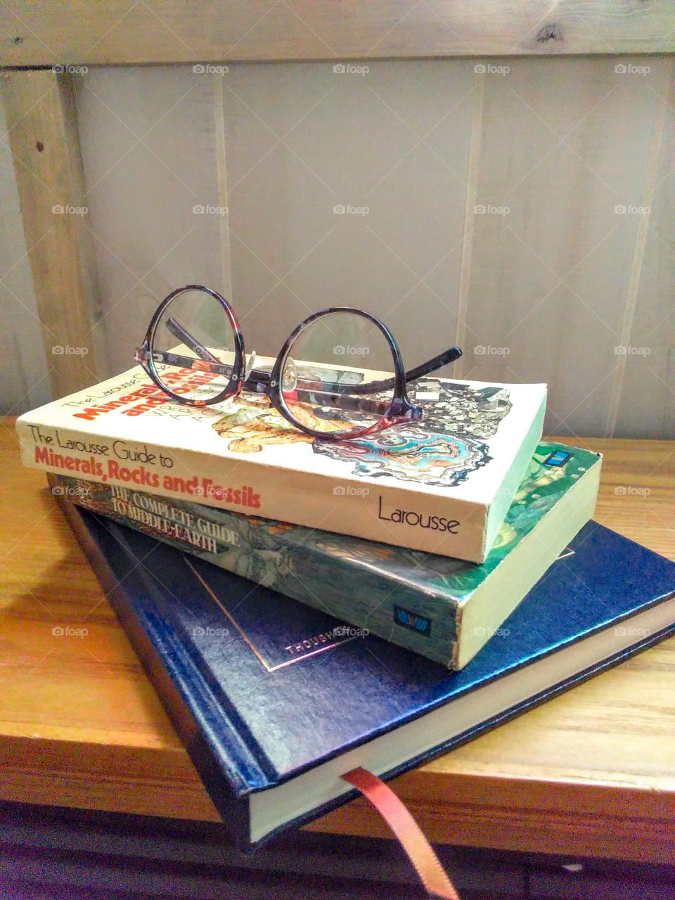 A pair of glasses on a stack of books
