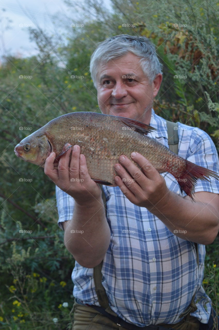 Senior man holding fresh fish