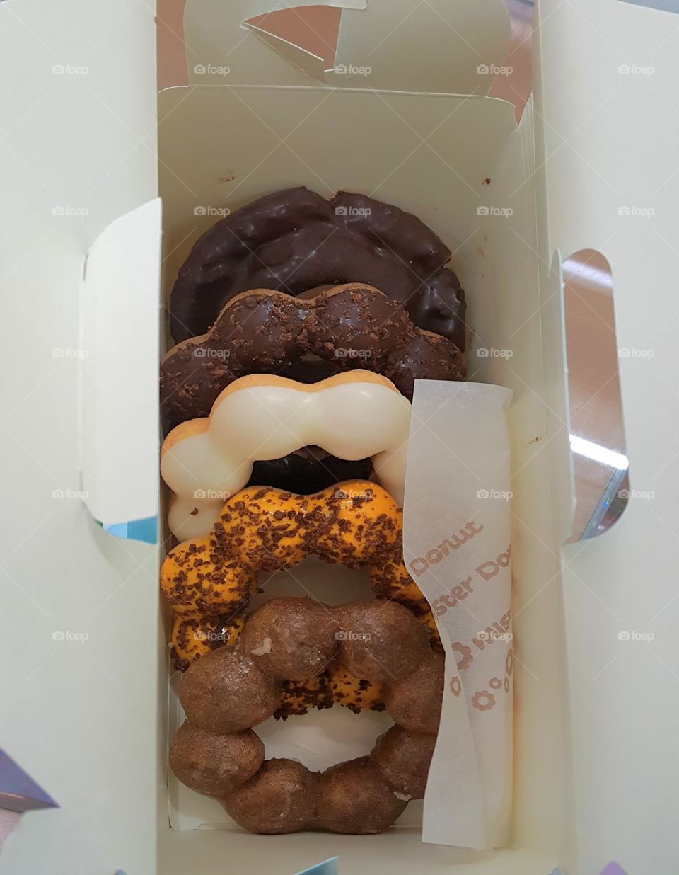 A box of donuts with various flavors