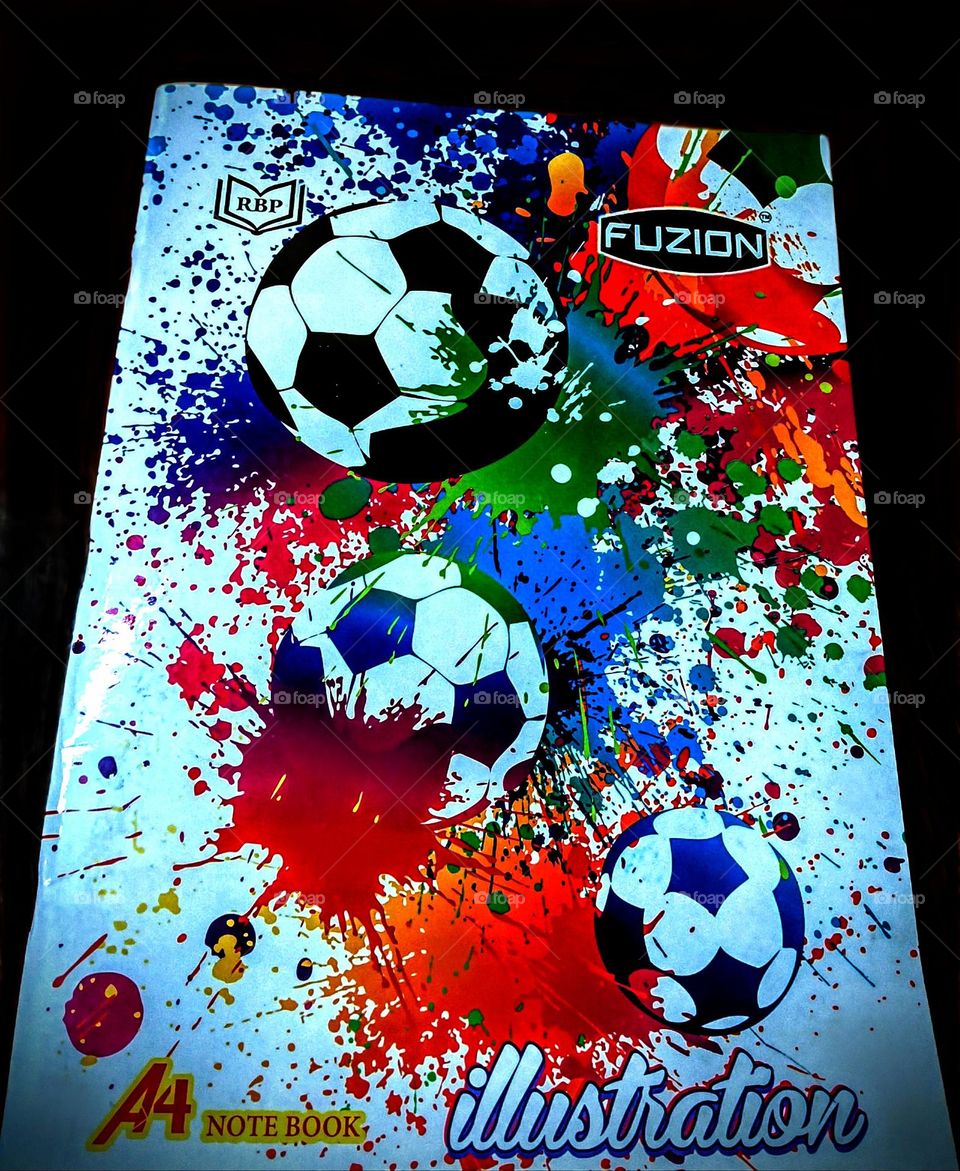 A vibrant A4 notebook cover with dynamic color splashes and soccer-themed illustrations, symbolizing energy, creativity, and movement. The splatter art reflects spontaneity, inspiring free expression and an engaging experience.