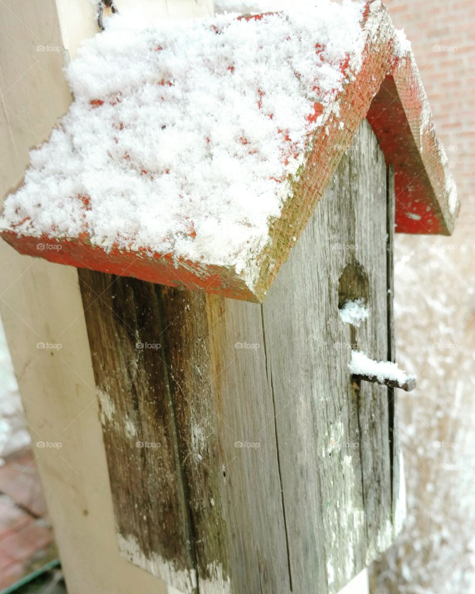 snow covered birdhouse