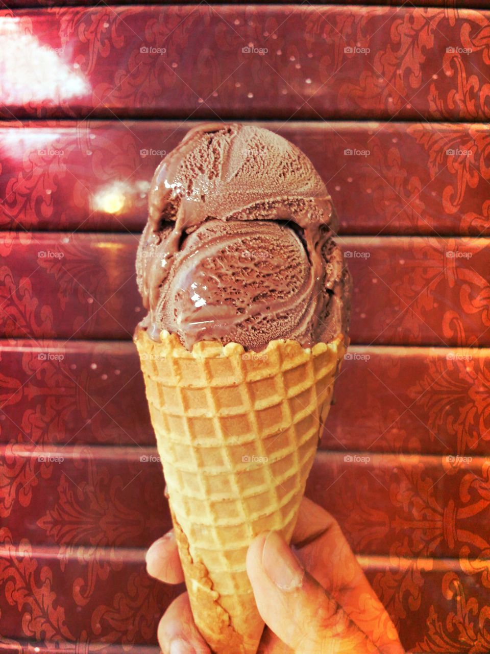 Chocolate.. Chocolate ice cream cone on the red wall. It's delicious at Pai walking street Maehongson Thailand.