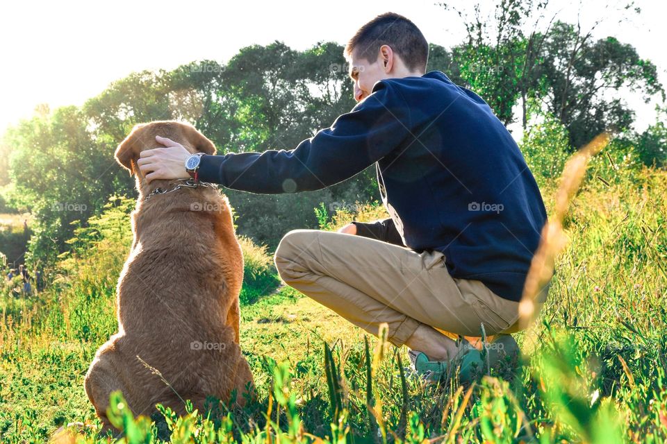 Close-up of a man with dog on grass