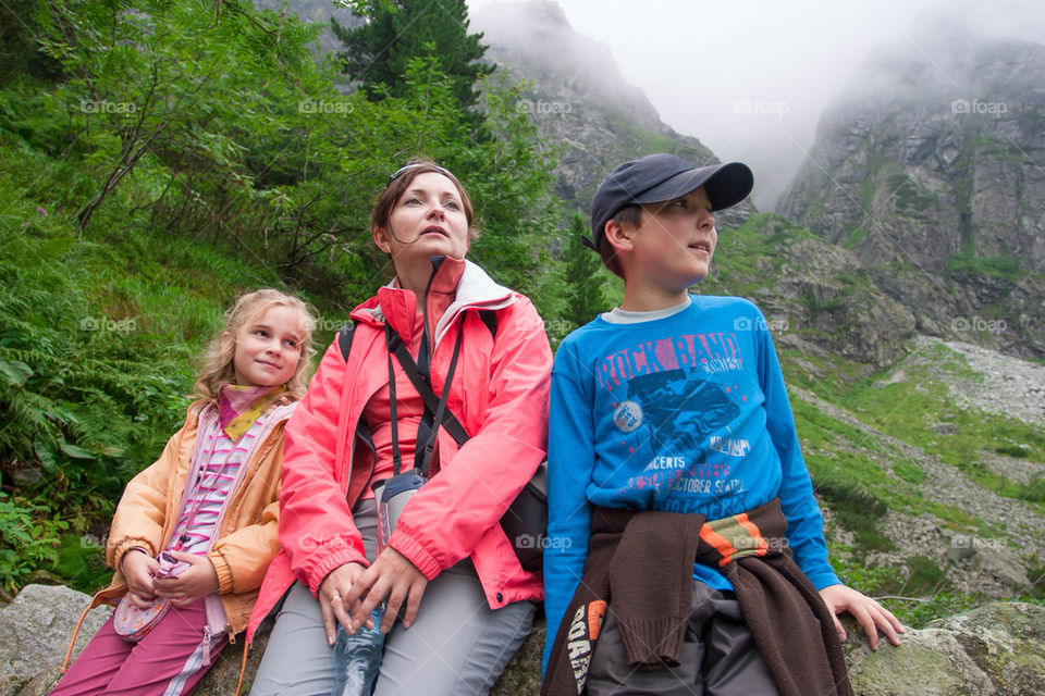 Family resting on mountain trail