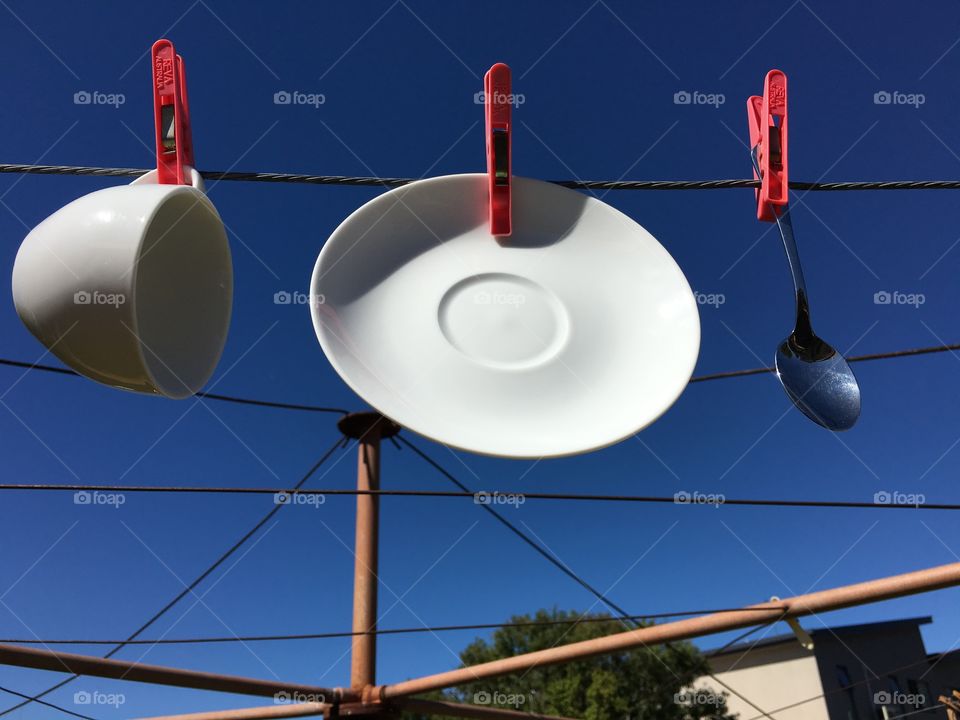 A husband's way of doing dishes? Frugal living.. Dishes hanging to dry in a clothesline   Solar energy?