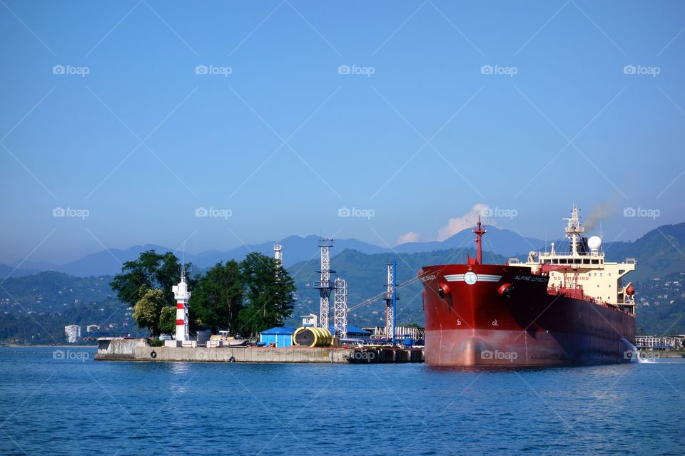 Oil tanker in Batumi oil terminal on a sunny summer day. A large size oil tanker loading crude oil in Batumi oil terminal on a cloudless sunny July day in 2014.