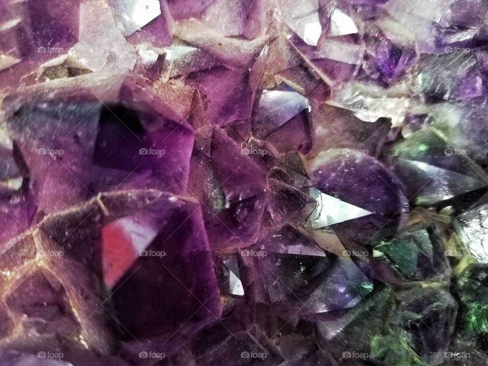 apurple amethyst points in a geode cluster