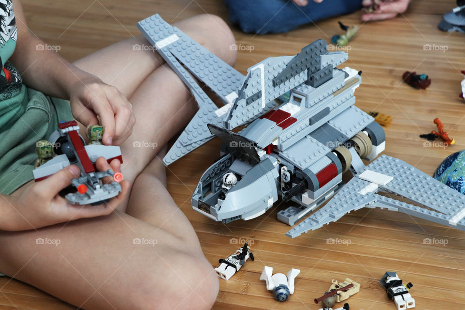 Child playing with Lego Star Wars