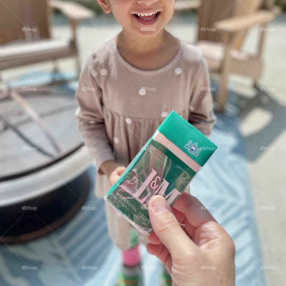 Little girl finds a pack of cigarettes in backyard, L & M cigarettes, finding things in the yard, found items 