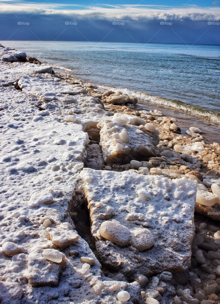 Broken frozen sand on the beach of Lake Michigan