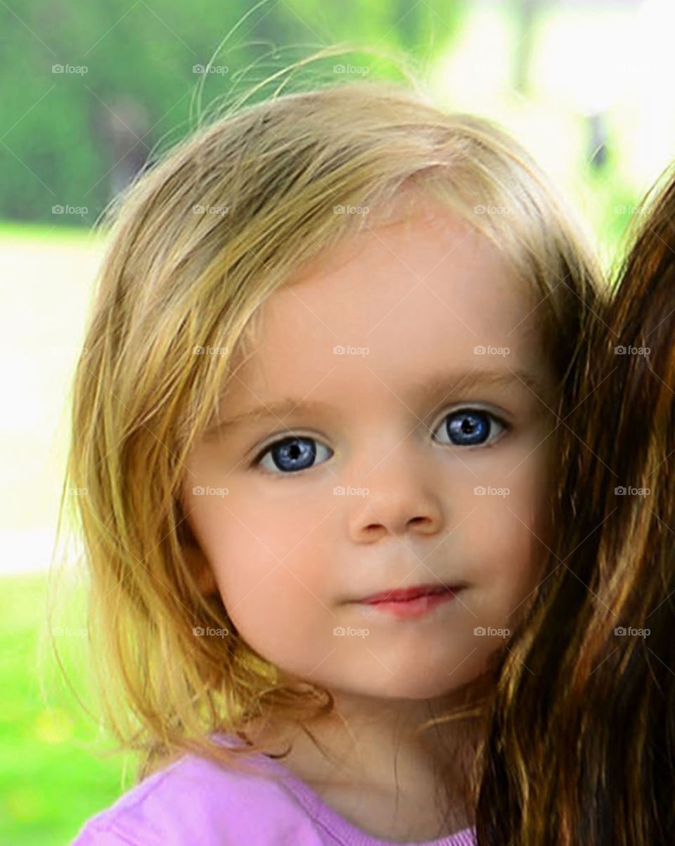 Close-up of a little girl looking at camera