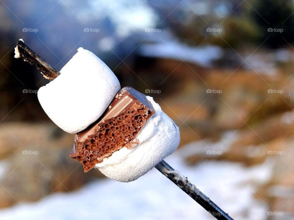 Toast marshmallows over a fireplace