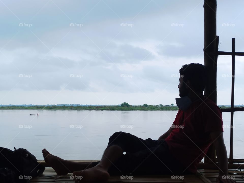 sitting and watching nature beauty is the best thing you can do . feel the fresh air touching your face and see the beauty of nature the huge sky and blue water.