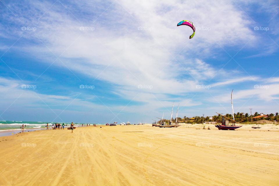Kitsurfing and busy beach on summer weekend