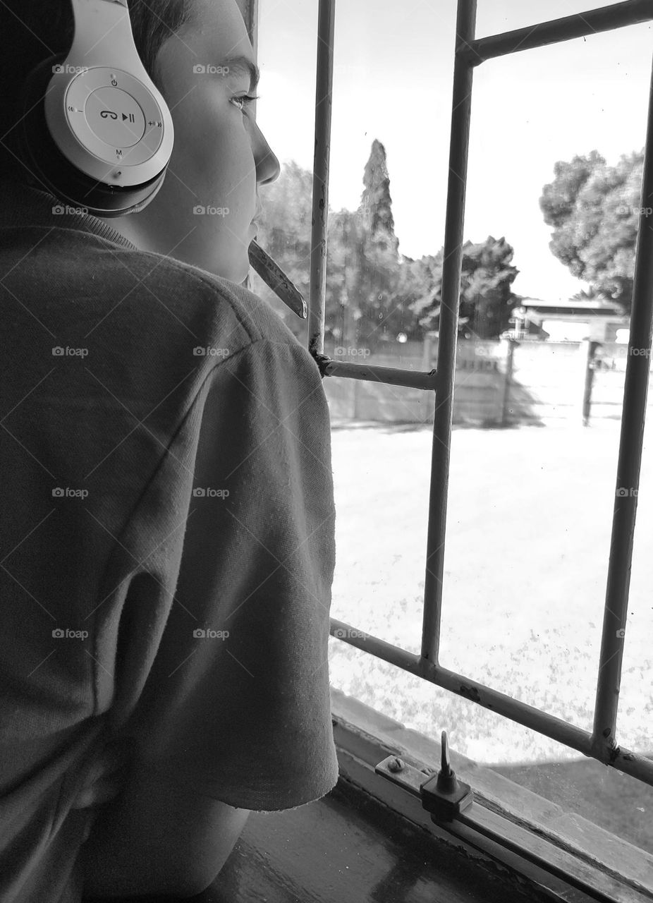 Young male looking out of the window