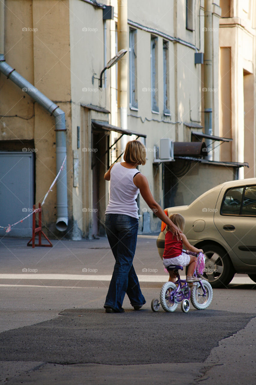 Young mother and child with bicycle 