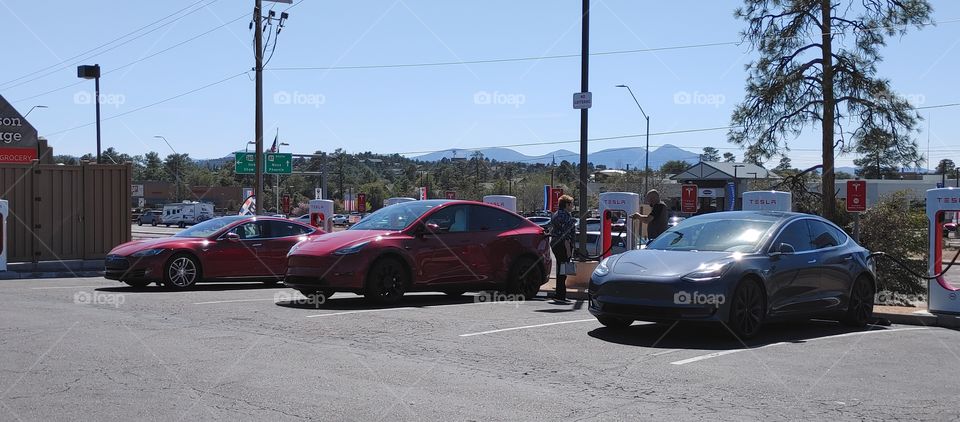 Telsa's charging with owners talking