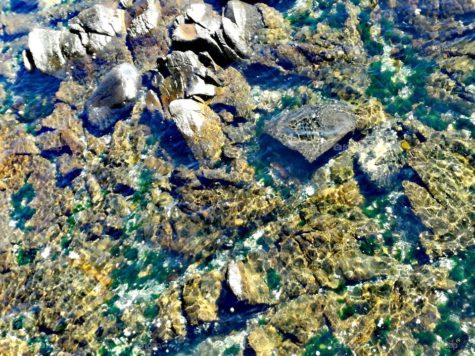 sea rocks seethrough water scenic