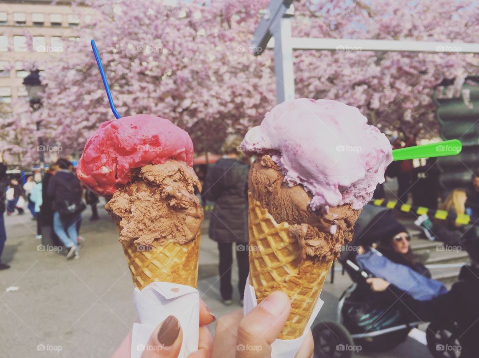 Human's hands holding ice cream waffle cone 