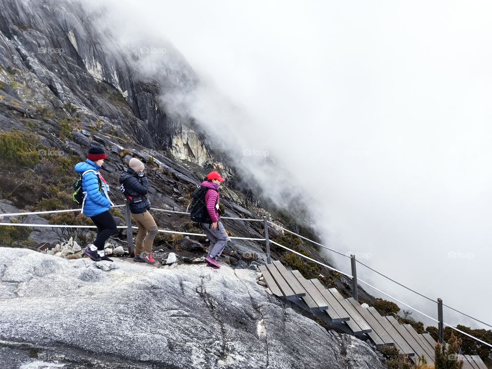 Unidentified Hikers climb down the wooden staircase at mount Kinabalu, Sabah Borneo, Malaysia