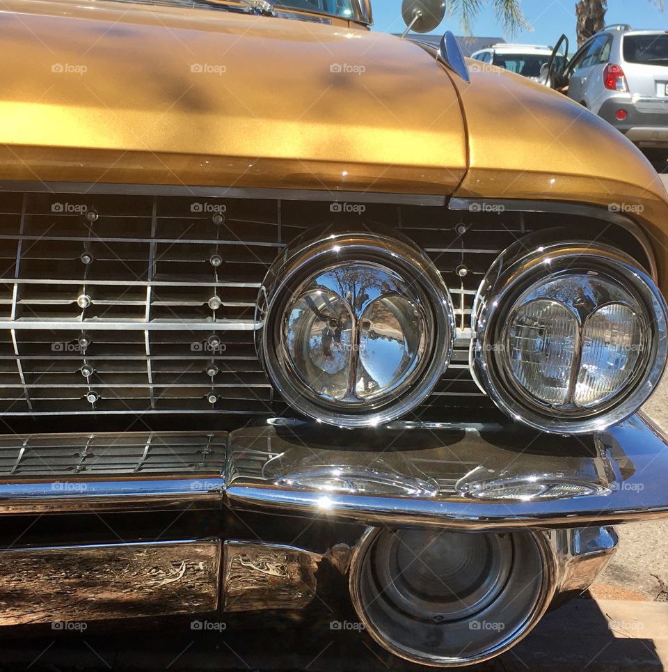 Classic gold 1961 Cadillac deVille cats eye headlights, and chrome grill