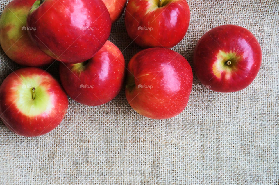 Red apples on sackcloth background 