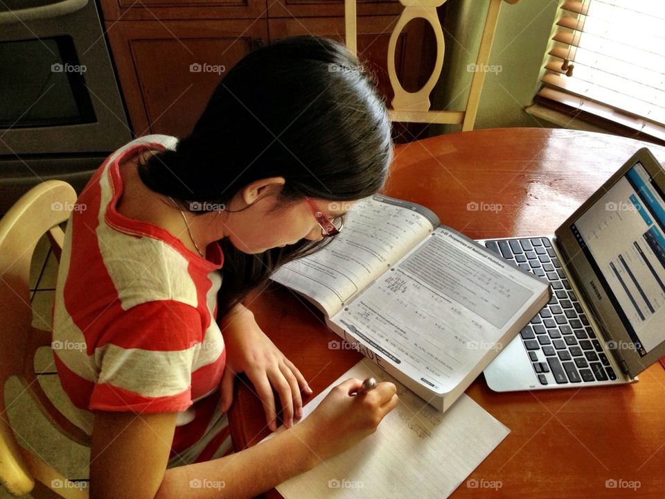 Young girl studying in the house