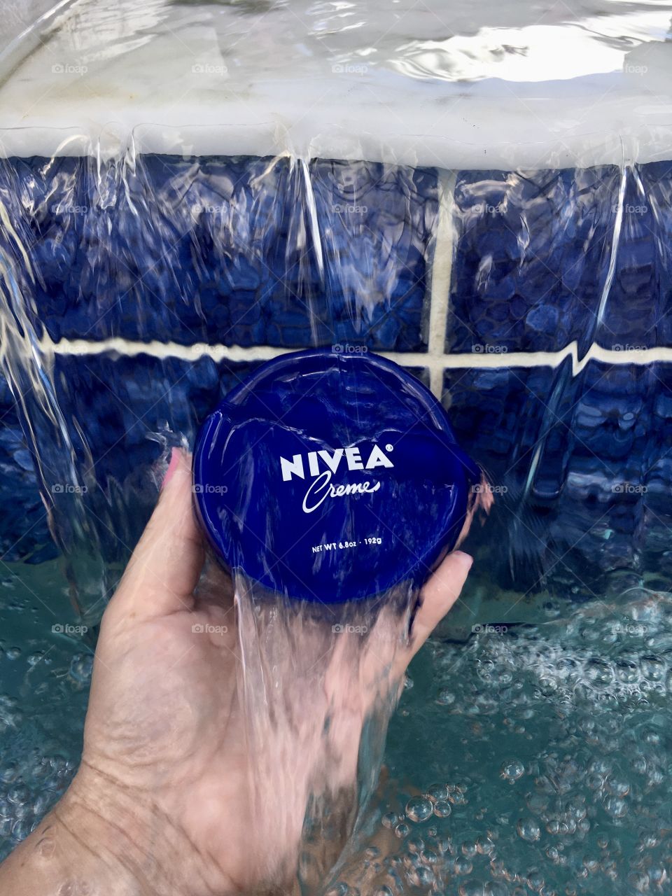 Nivea creme held by hand