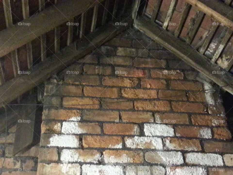damp chimney breast in a loft of a country house depicting mould