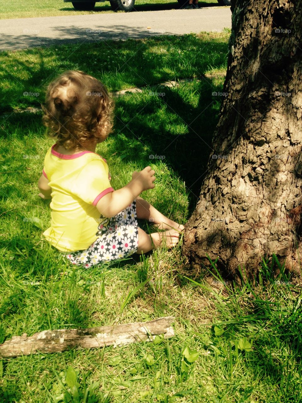 Toddler Sitting by Tree
