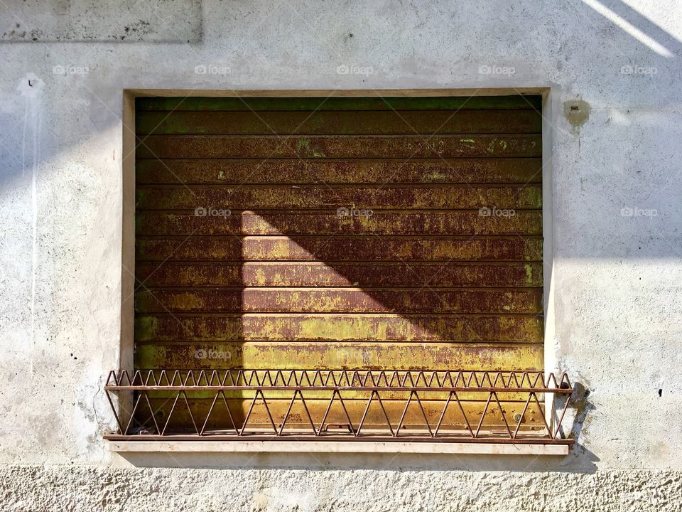 A closed showcase, a symbol of the economic crisis and the abandonment of small local shops caused by the indiscriminate increase of large shopping malls