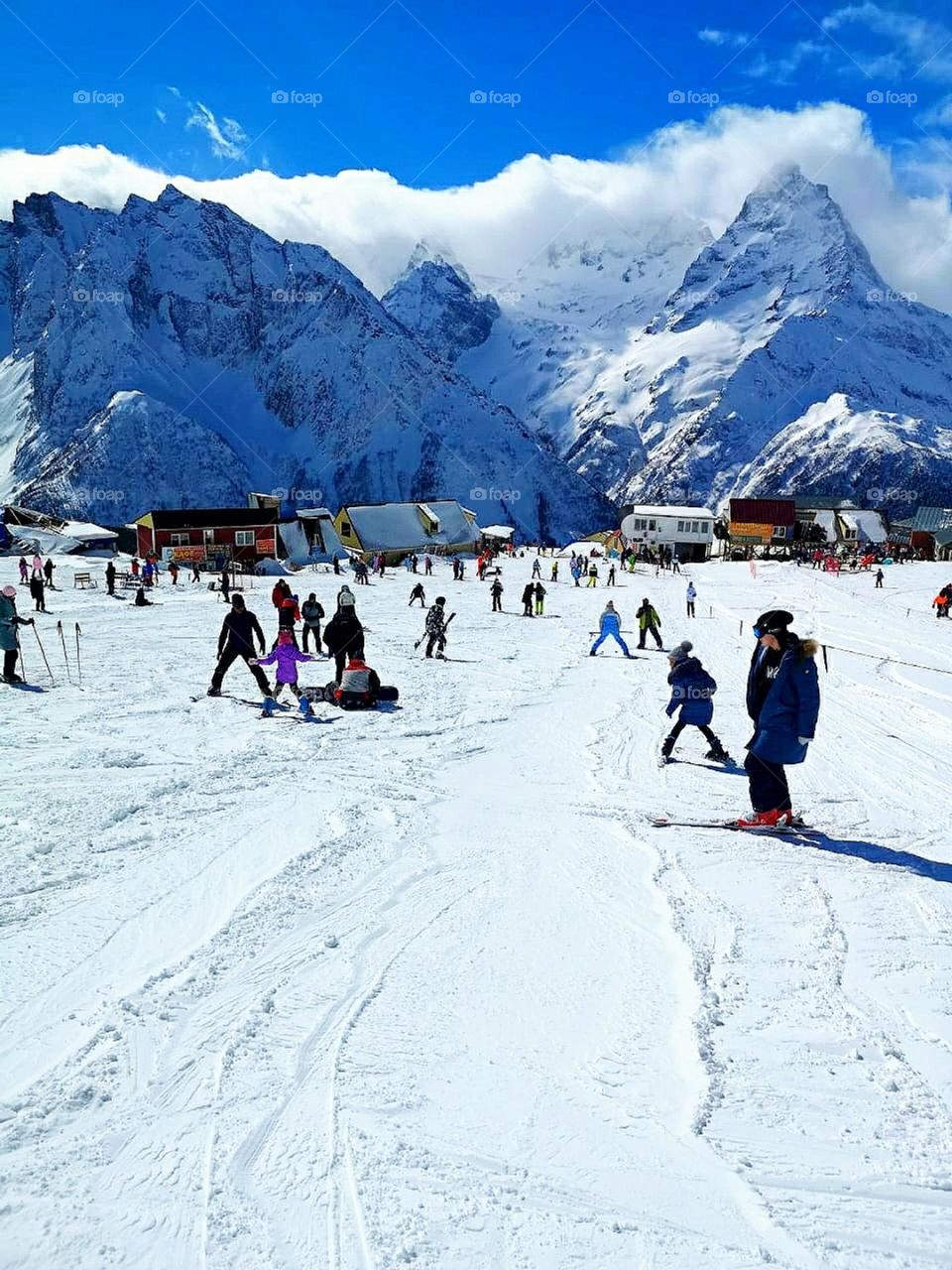 Winter. Winter mountains. Children and adults skiing