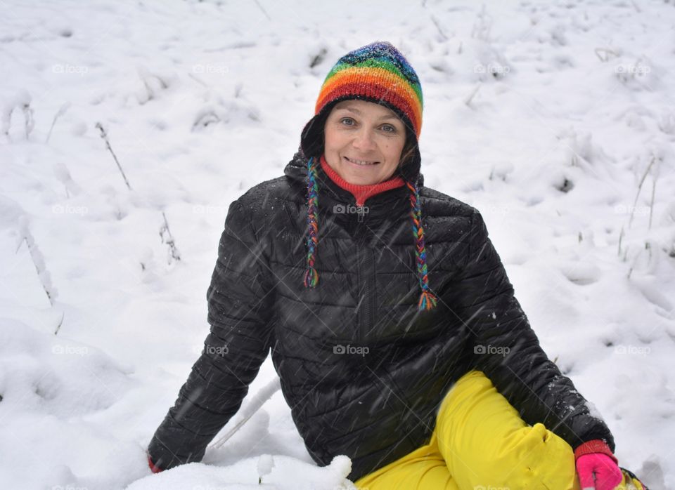 smiling woman in the snow winter time