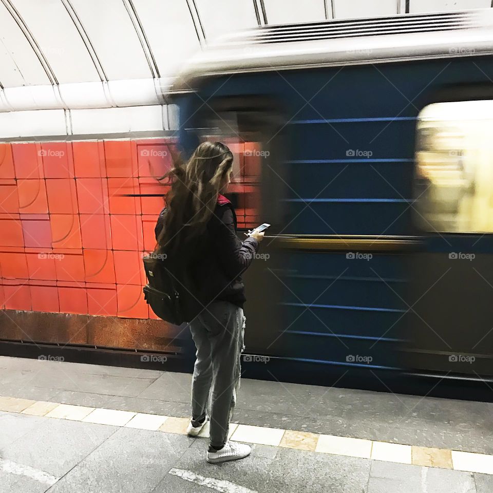 Using mobile phone at subway station 