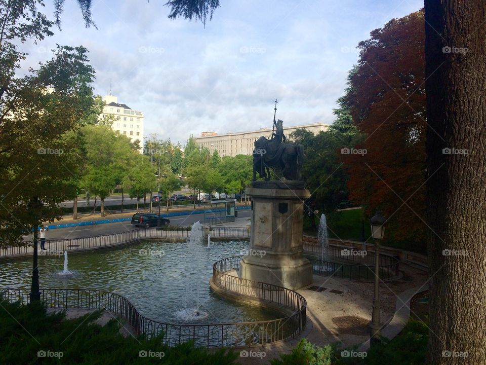 Large water fountain or water feature at a park in the city of Madrid in Spain and a statue in the middle 