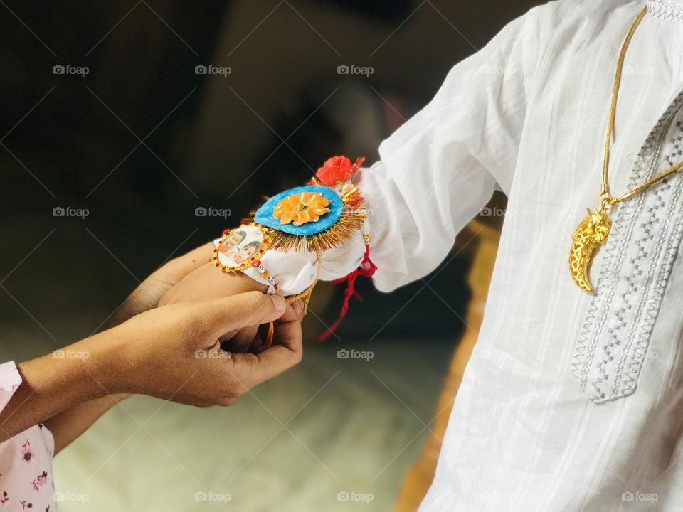 Indian festival rakhi pournima day , a sister ties band to his brother.it remains their relationship forever strong.