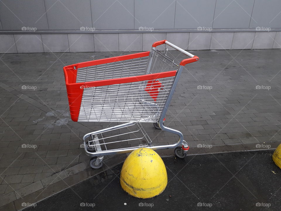 Carts for grocery products stand near a supermarket on the street