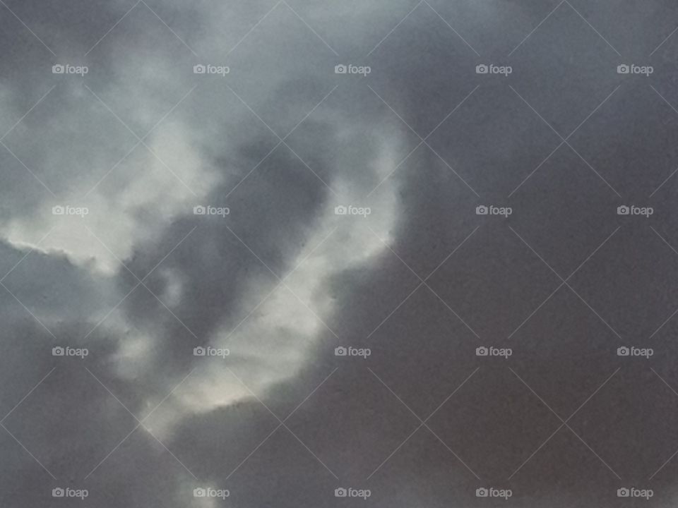 A special evening view of the clouds in the sky with a child's face, looking down.