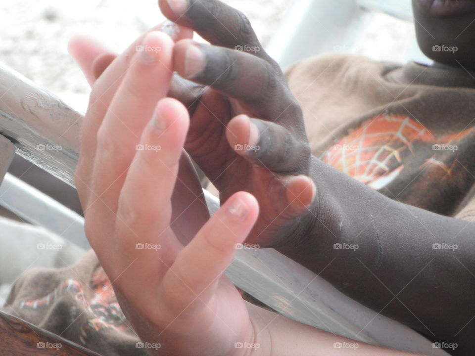 A Hand to Hold. Holding the hand of a little boy in a Haitian orphanage.