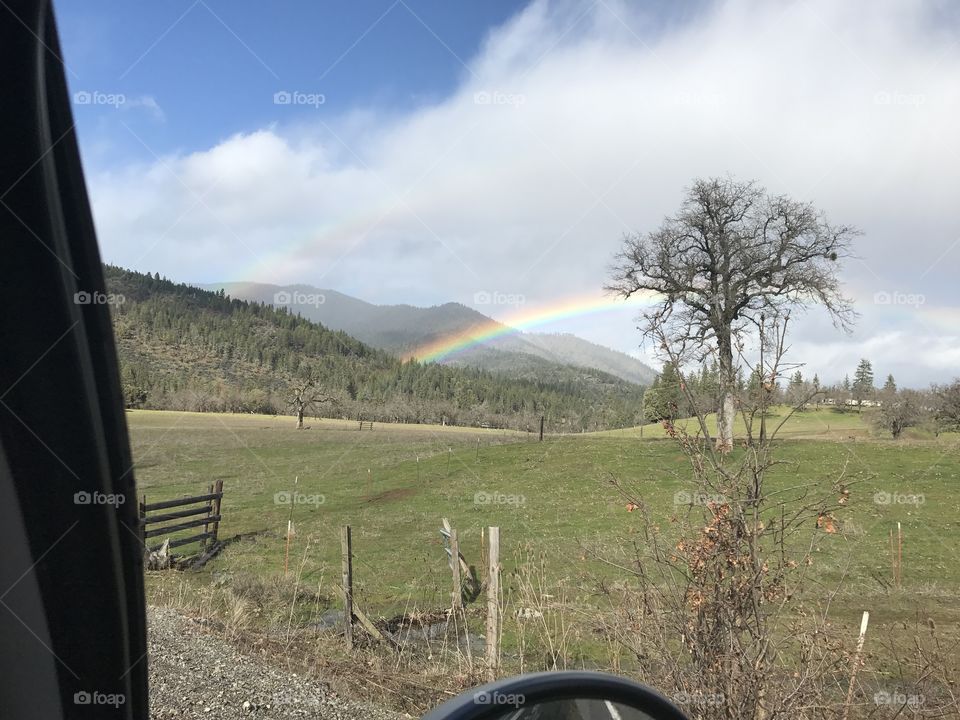 Rainbow in farm field