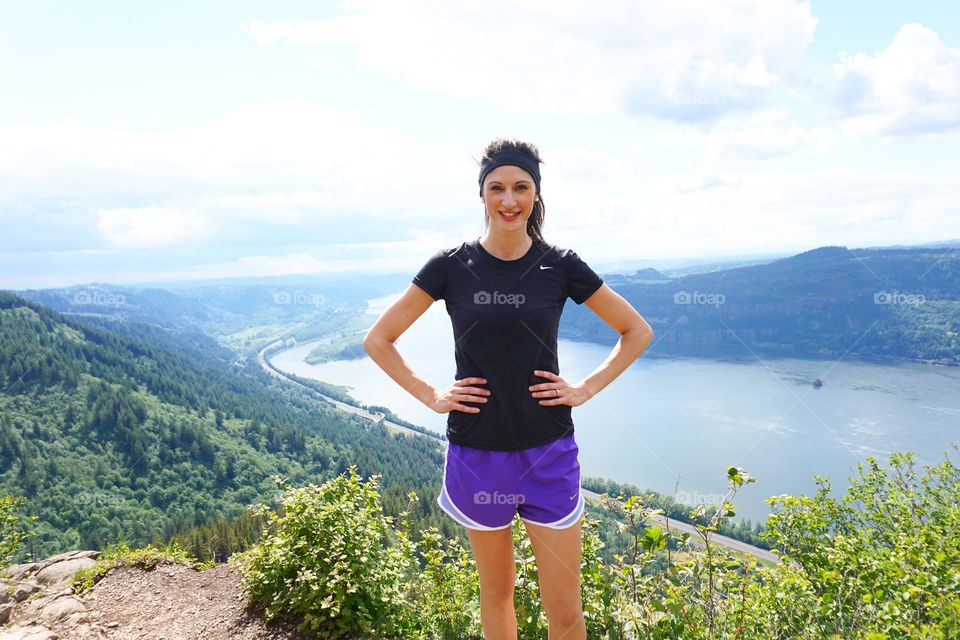 Fitness woman standing on mountain