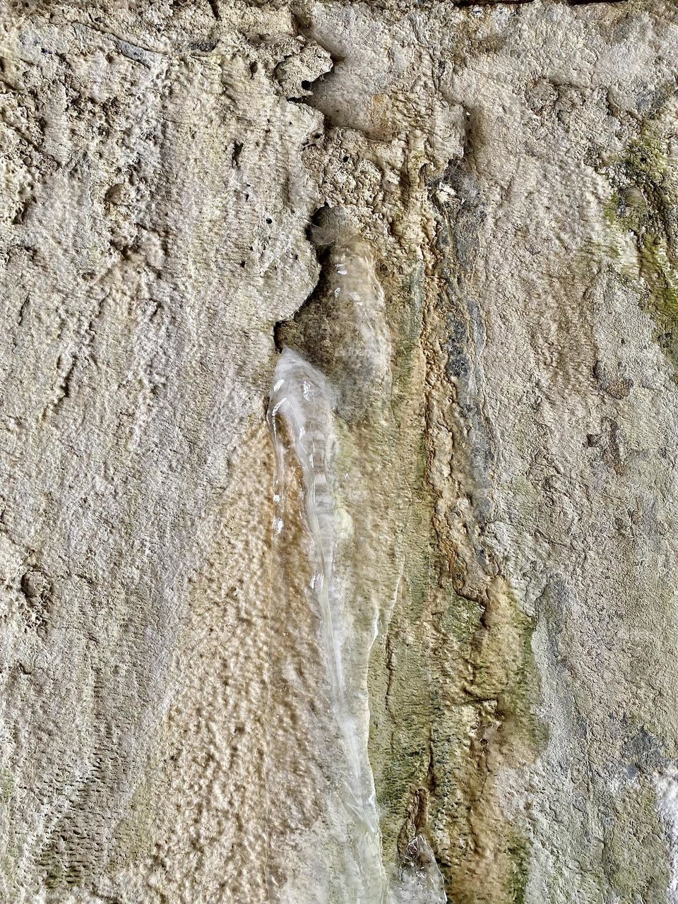 Ice on the side of a tunnel formed from water coming out of a pipe