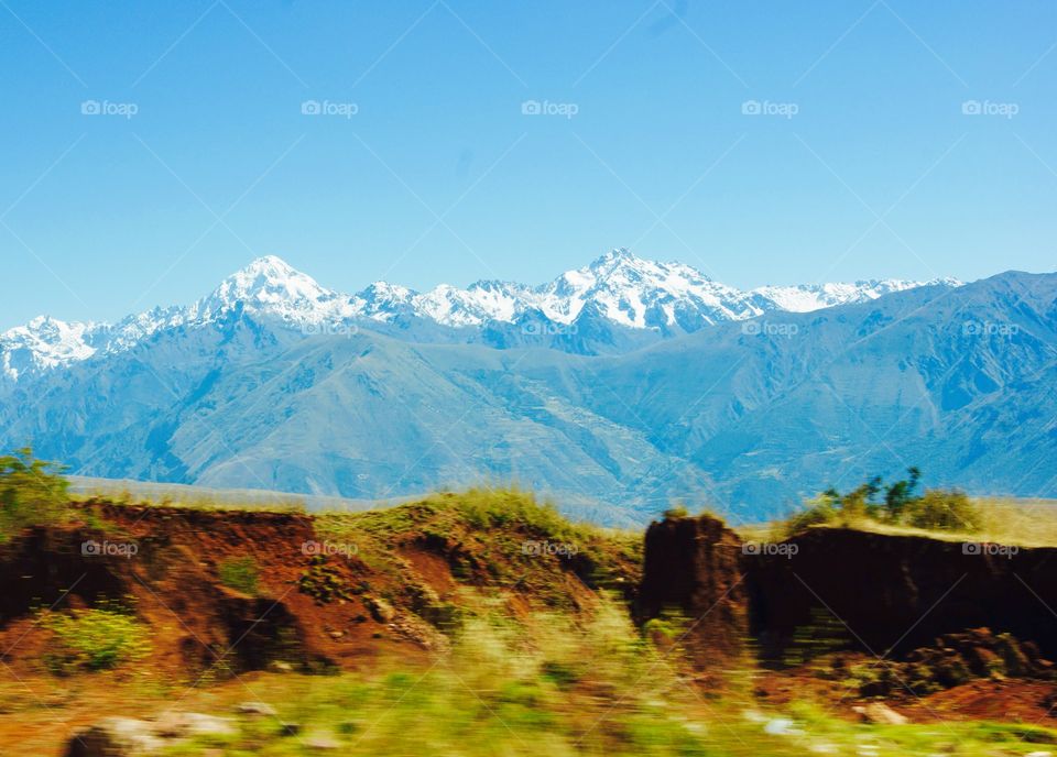 Snow capped mountains captured from a moving car in Peru 