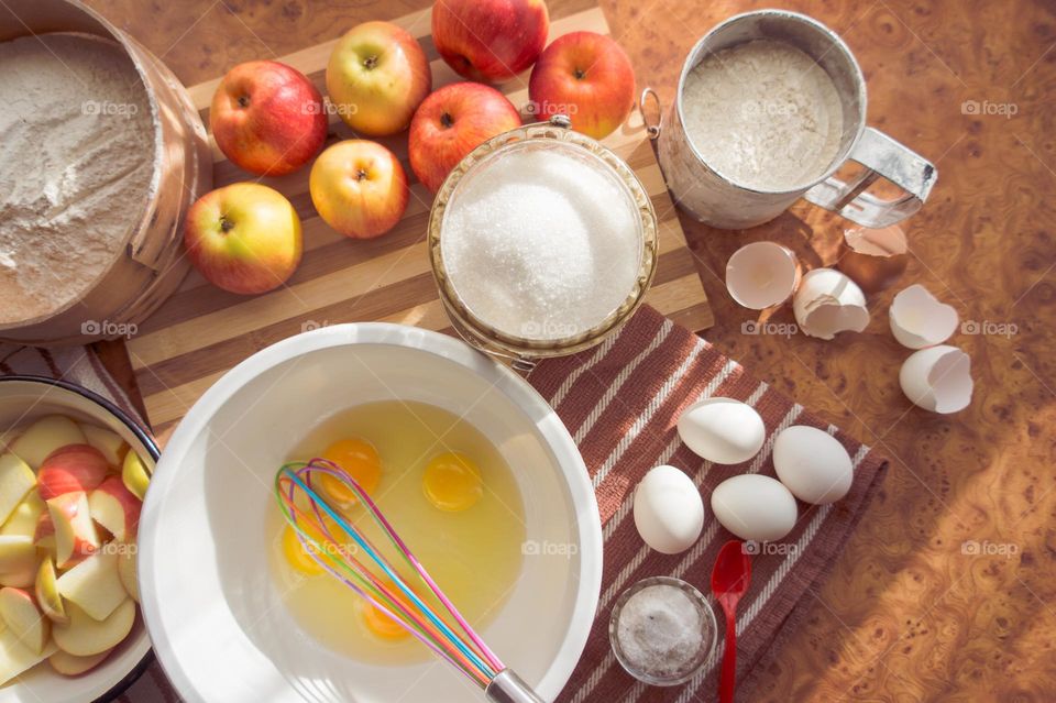 Making homemade puffed apple pie with eggs, sugar and flour.