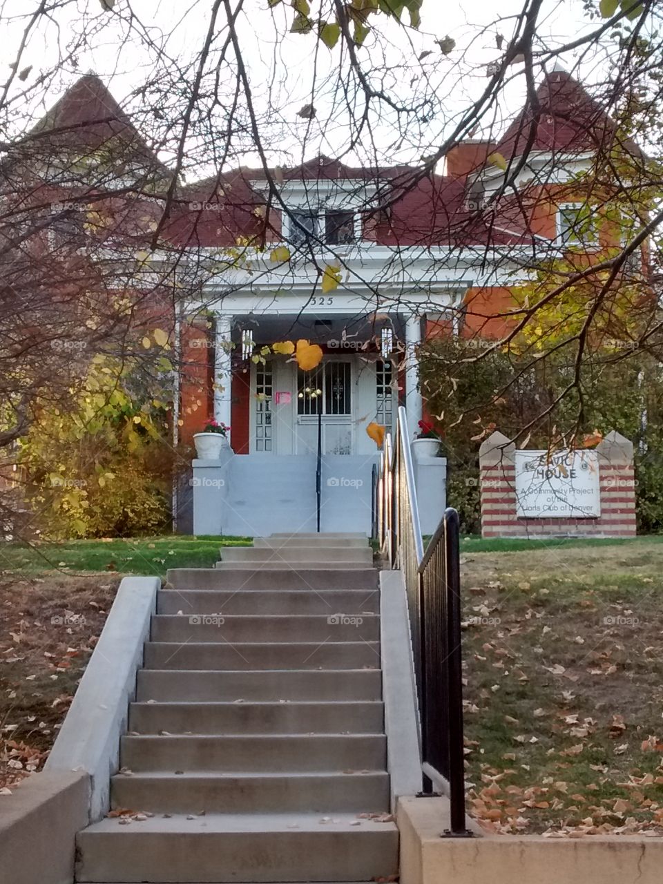 red brick mansion stairs and golden trees