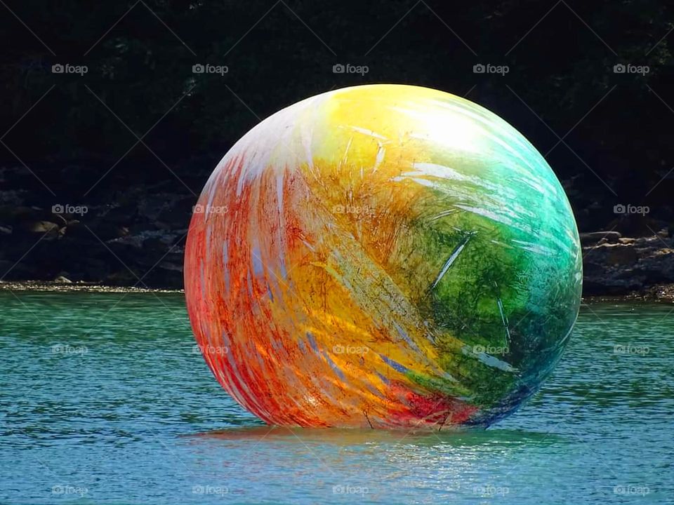 A huge colourful ball floating on the sea in Haliguen port in Douarnenez