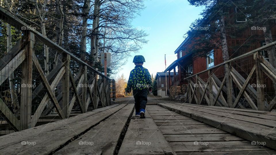 Little boy walking on the bridge