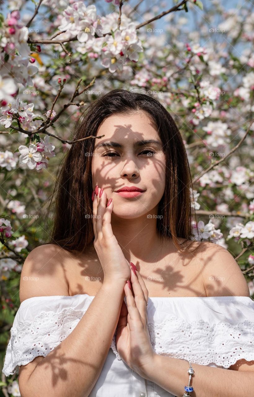 beautiful woman in spring blossom trees